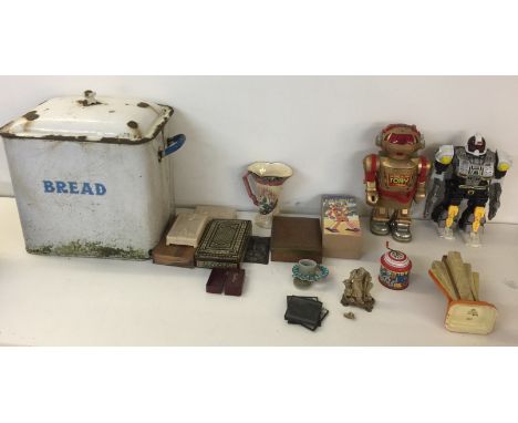 ASSORTED COLLECTIBLES. To include: three assorted robot figures (one boxed), two bread tins, a carved oriental figure, five g