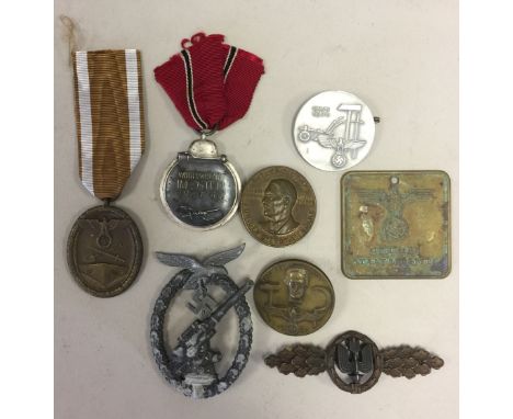 THIRD REICH. Eight assorted medals, tokens and badges to include: a 1941/42 Winter War medal, a 1934 Labour Day pin, a Gestap
