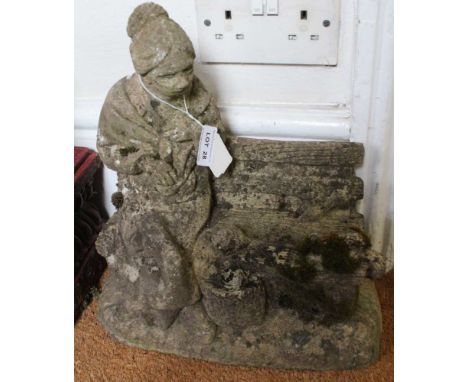 A CAST GARDEN FIGURE OF A LADY feeding squirrels on a bench 