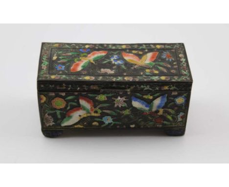 A CHINESE ENAMELLED METAL STAMP BOX, of casket design raised on bracket feet, enamelled in the round with butterflies amidst 