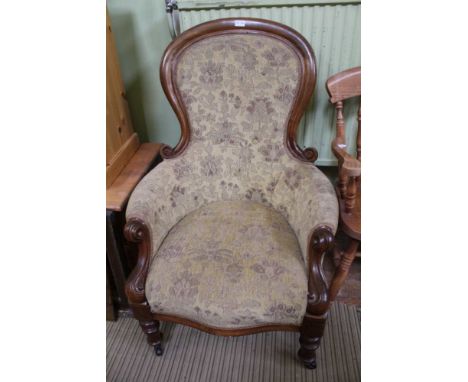 A MAHOGANY SHOW WOOD FRAMED VICTORIAN DESIGN DEEP SEATED ARMCHAIR, with floral upholstery, on turned fore legs, plain rear, w
