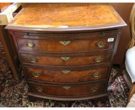 A WELL MADE REPRODUCTION BOW FRONT CHEST OF DRAWERS, having brushing slide, over four full width graduating drawers, supporte