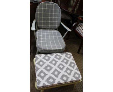 A LATER PAINTED ERCOL DEEP SEATED ARMCHAIR with fleur-de-lis back, together with a low footstool 