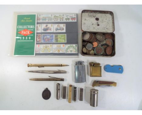 A small quantity of UK and foreign coins, a small quantity of British mint stamps (approx £4.50 face value), a vintage Ronson