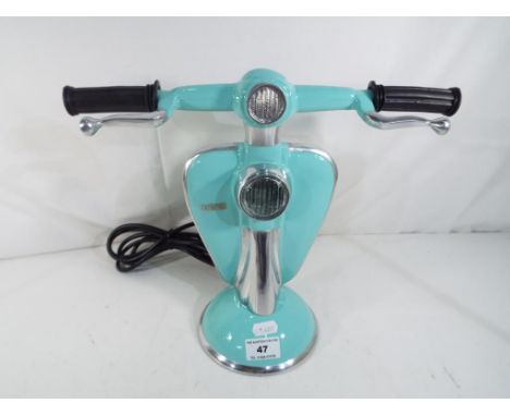 An unusual turquoise lamp in the form of a Lambretta scooter, 28 cm (h). Estimate £50 - £80 - This lot MUST be paid for and c