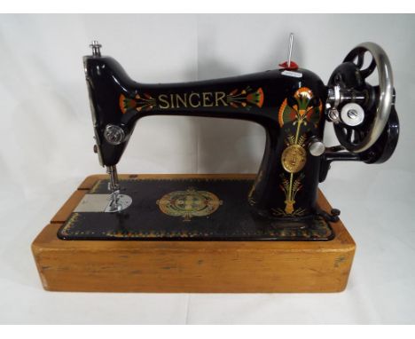 A decorative vintage Singer Sewing Machine Est £10 - £20  This lot MUST be paid for and collected, or delivery arranged, no l
