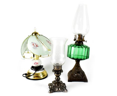 An Edwardian oil lamp with green glass reserve to an Art Nouveau metal base, height 49cm, a candle holder in the form of a sm