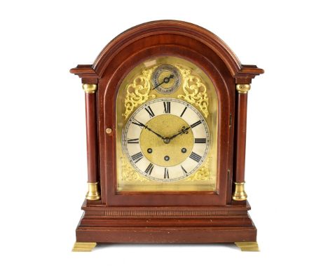 An early 20th century Gustav Becker eight-day chiming mantel clock, the gilded dial with raised scroll decoration and silvere
