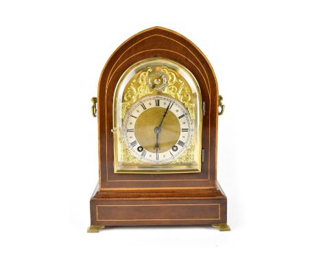 A c1890 inlaid mahogany lancet bracket clock, the gilded dial with raised decoration, silvered chapter ring set with Roman nu