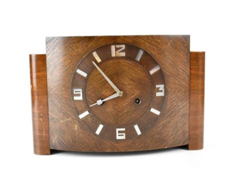 An early/mid-20th century Art Deco oak-cased eight-day mantel clock, the dial set with silvered baton and Arabic numerals, he