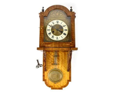A late 19th century Vienna-style wall clock, the gilded dial with raised scroll decoration, the enamelled chapter ring set wi