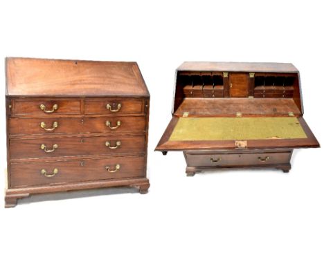 A George III mahogany bureau, the fall front revealing a fitted interior above two short and three long graduated drawers, on