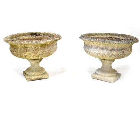 A pair of reconstituted stone planters of circular form, on pedestal bases, height 50cm, diameter 65cm. CONDITION REPORT One 