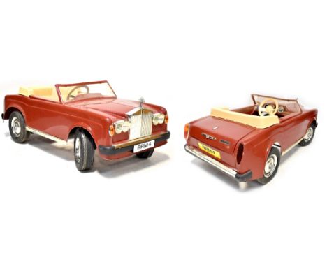 A 1980s Rolls Royce Corniche child's electric car in red, lacking charger (af), length 120cm. CONDITION REPORT Dummy key is m