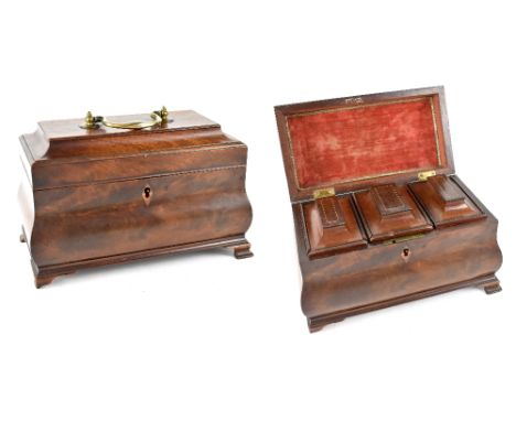 A Georgian mahogany tea caddy of bombé form, with brass drop handle to lid revealing a fitted interior of three compartments 