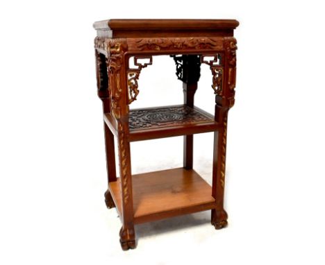 An Oriental stained hardwood jardinière stand with rectangular top, on pierced and carved legs with carved under tier and pla