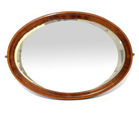 An Edwardian mahogany-framed oval bevel edged wall mirror, 61 x  84.5cm.