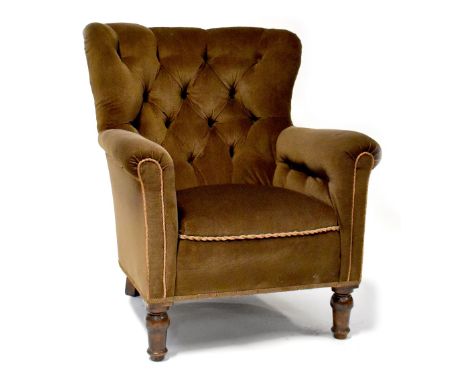A 1930s walnut button-back armchair upholstered in brown velour and on turned feet. CONDITION REPORT No castorsupholstery app