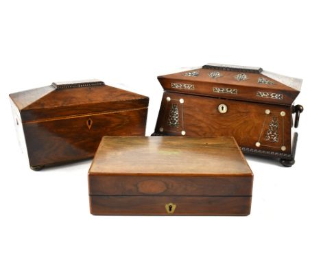 An early 19th century rosewood and mother of pearl inlaid sarcophagus tea caddy with wooden ring carrying handles, original l