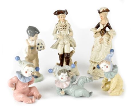 A group of four Nao figures, three babies dressed as jesters, a boy carrying a football and two other figures in 18th century