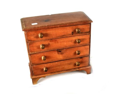 An early 20th century pine four-drawer apprentice chest on bracket supports, 30 x 32cm.
