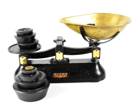 An early/mid-20th century Avery black cast iron set of kitchen scales with brass pan and a quantity of weights, from 4oz to 4