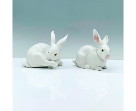 Pair of Lladro Figurines, Preening Bunny 1005906 and Attentive Bunny 1005905. 2 white porcelain rabbits that are decorated wi