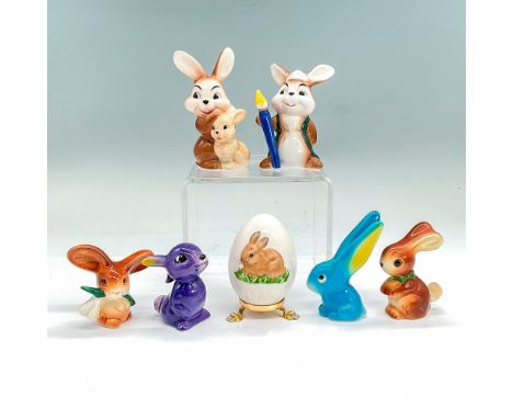 Six glazed porcelain figures of rabbits and one egg with an image of a little brown bunny in a golden footed stand. Goebel ba
