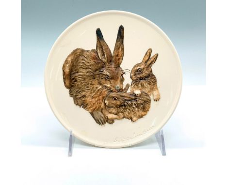 Hand painted plate depicting a mother bunny rabbit with her babies. Artist signature impressed at the bottom. Goebel backstam