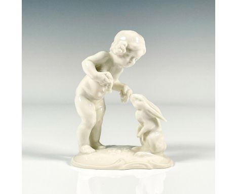 Vintage figure depicting girl child feeding a rabbit. White glaze finish, Art Deco style. K. Tutter marked to underside. Huts