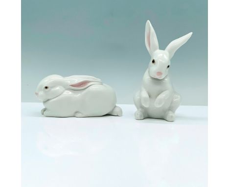 Pair of Lladro Figurines, Sitting Bunny 1005907 and Sleeping Bunny 1005904. 2 white porcelain rabbits that are decorated with
