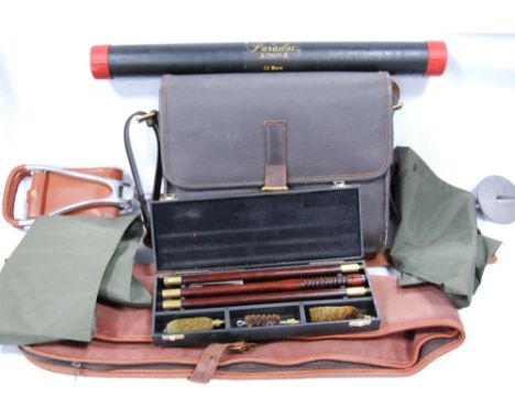 Tan leather shooting bag, 35cm high; a Parker-Hale 12 gauge gun cleaning set; a canvas gun slip; a shooting stick; a folding 