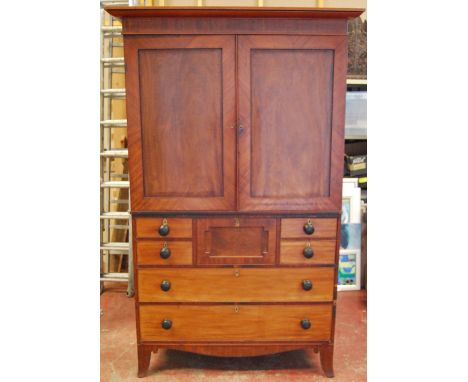 Regency mahogany linen press with plain cornice, the interior fitted with slides over an arrangement of drawers, on splayed b