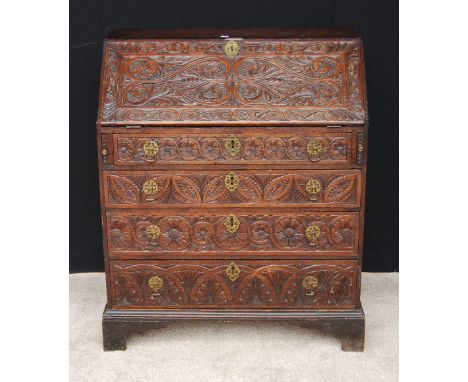 George III oak bureau with later floral carving, on bracket feet, 99cm high and 82cm wide.