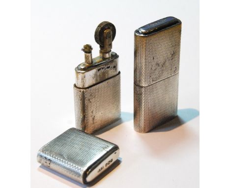 Pair of silver 'Howitt' lighters with engine-turned cases, Sheffield hallmarks, 6cm long.