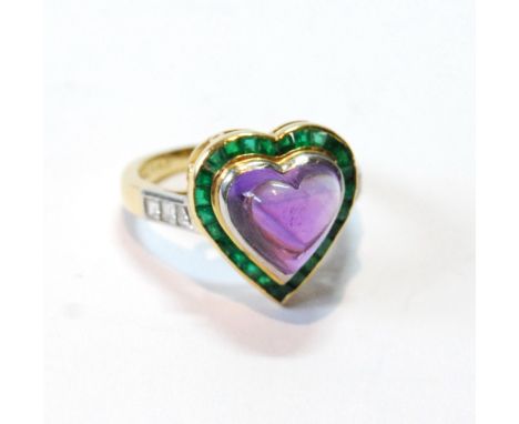 Ring with heart-shaped cabochon amethyst surrounded by small calibré emeralds, in 18ct gold.   Condition Report  The stones o