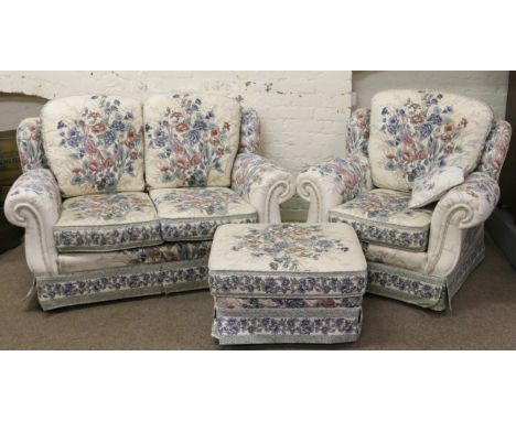 An upholstered floral pattern two seat sofa and arm chair along with matching pouffe.