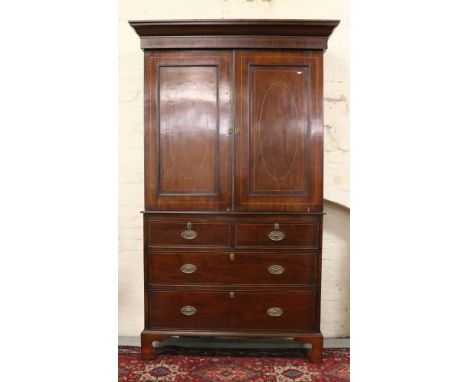 A Georgian mahogany linen press with fitted interior raised on bracket feet.