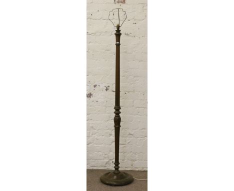 A fluted and carved mahogany standard lamp.