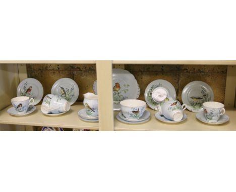 A six place part tea service handpainted with birds and flowers.