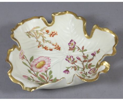 A Royal Worcester leaf moulded dish with gilded rim and enamelled with flowers, puce mark.
