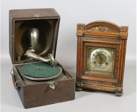 An oak cased mantel clock chiming on a coiled gong along with wind up picnic gramophone, both in need of restoration.