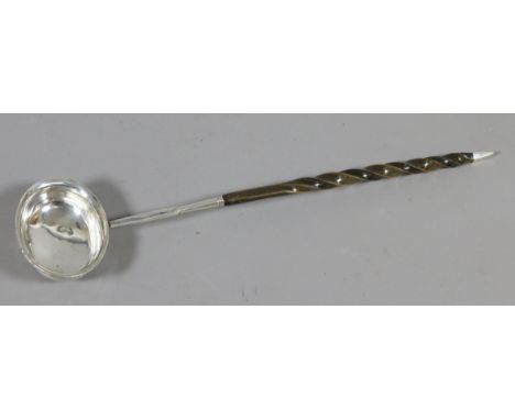 A Georgian white metal toddy ladle with whale bone twist handle.