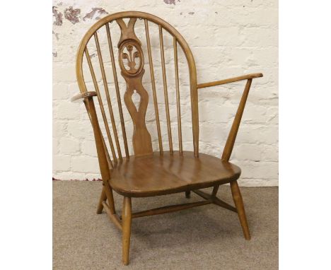 A light Ercol spindle back nursing chair with Prince of Wales motif.