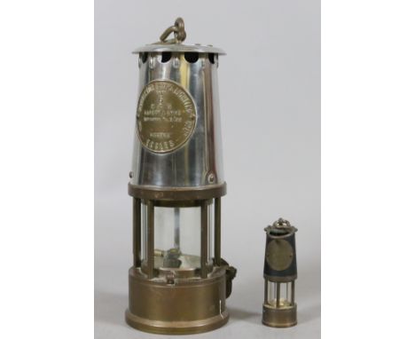 A Eccles miners Davey lamp and similar miniature example.