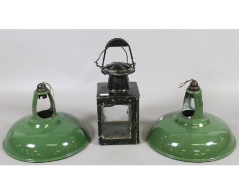 A pair of green enamelled light fittings and a painted oil lantern.