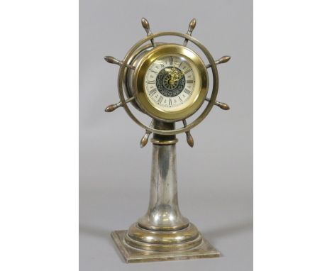 A German silver plate on brass mantel clock formed as a ships wheel.