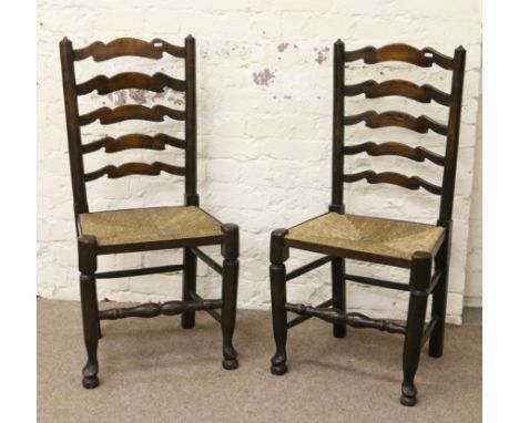 A pair of rush seat ladder back chairs of Titchmarsh and Goodwin style.