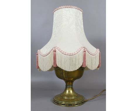 A brass based tablelamp in the form of an oil lamp.