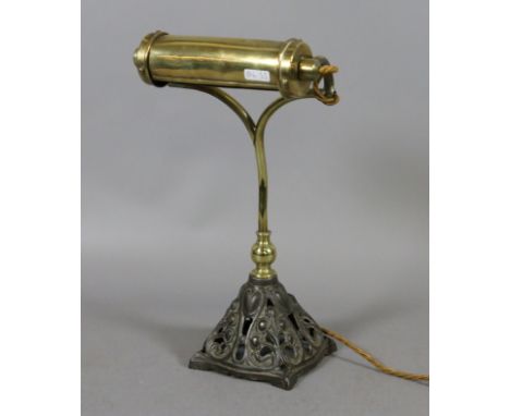 An Art Nouveau brass and iron desk lamp.